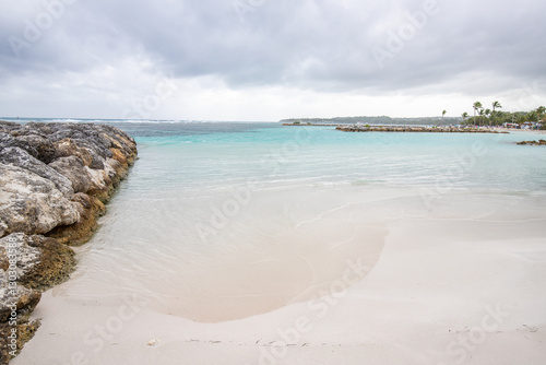 Fototapeta Naklejka Na Ścianę i Meble -  Romantic Caribbean sandy beach with palm trees, turquoise sea. Morning landscape shot at sunrise at Plage de Bois Jolan, Guadeloupe, French Antilles

