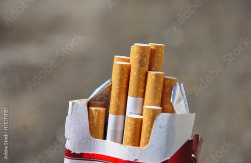 open pack of cigarettes on blurred background