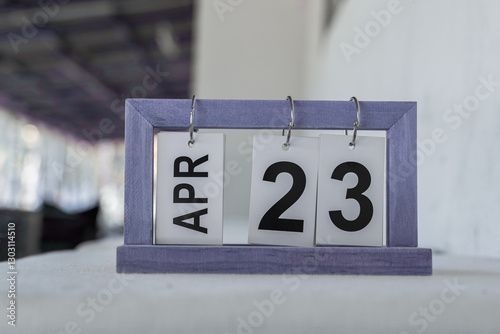 Wooden desk calendar, page 23 April. World Book and Copyright Day, to promote reading, writing and copyright protection.