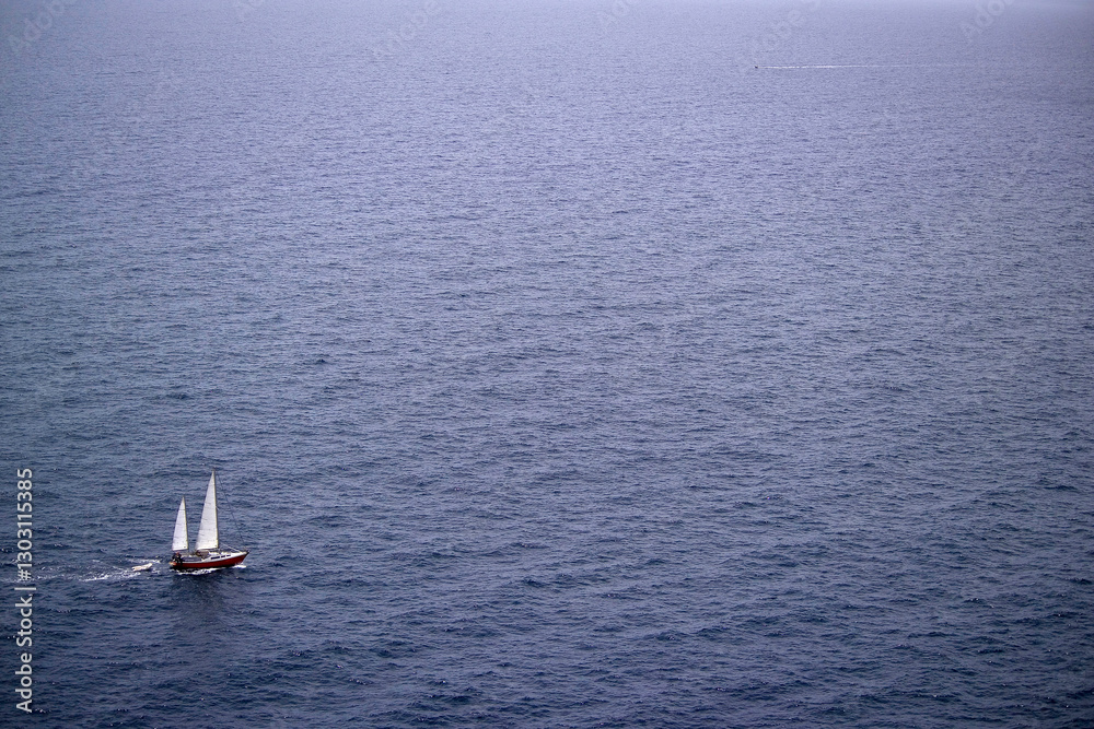 Fototapeta premium sailing boat on the sea off Capo Caccia. Alghero, Sardinia. Italy