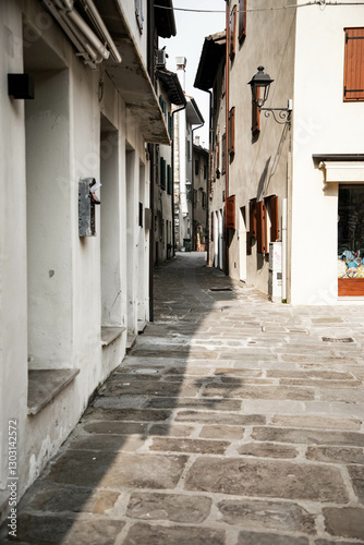 Fototapeta Naklejka Na Ścianę i Meble -  Grado, Italy: a small narrow street in the old town city center