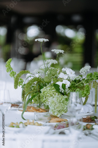 Elegant Dining Setup Featuring Lush Green Floral Arrangements