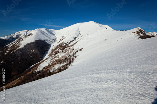 White snowy mountain in the blue sky, Pizzo Baciamorti, Val Taleggio, Val Brembana, Lombardia, Italy. photo