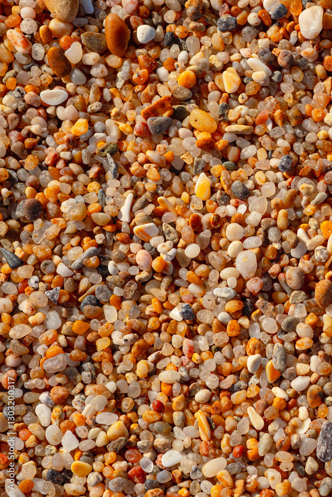 Beautiful texture of coarse beach sand. Beach-themed background image. Wet beach sand of large fraction Beautiful texture of coarse beach sand. Beach-themed background image. Wet beach sand of large fraction