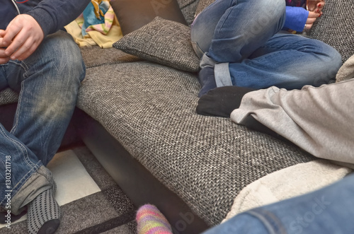 Cozy Living Room Scene with People on Sofa in Jeans and other normal clothes photo