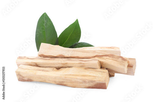 Pile of palo santo sticks and green leaves on white background