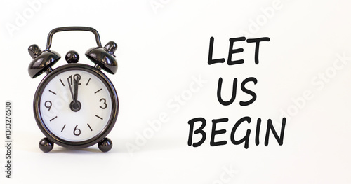 Let us begin symbol. Concept words Let us begin on beautiful white paper. Beautiful white background. Black alarm clock. Business motivational let us begin concept. Copy space.