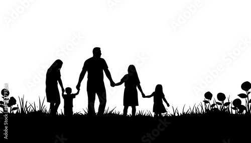 Silhouette of family holding hands in a grassy field