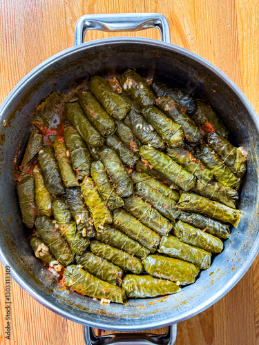 Delicious dolma sarma stuffed grape leaves rice, white yogurt sauce. Lebanese yaprak sarma on plate. Lebanon turkish greek middle eastern cuisine.