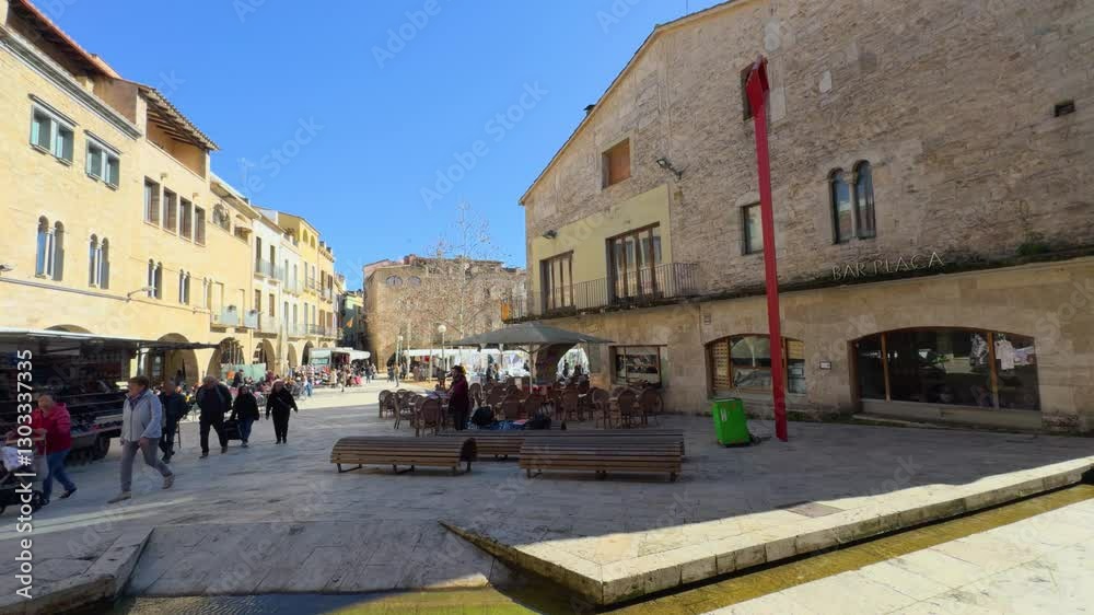 Tourists walking in placa major, besalu, spain