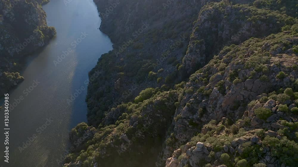 Aerial view of the cliffs and gorges of the Duero River during the sunset, in the area called Arribes del Duero, which divide Spain on one side and Portugal on the other. Aerial view of the cliffs and gorges of the Duero River during the sunset, in the area called Arribes del Duero, which divide Spain on one side and Portugal on the other.