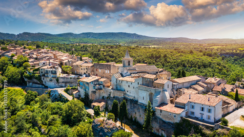 View of Venasque village with old church Notre Dame de Vie to landscape of Luberons, Provence, France. Beautiful Church and houses in the town of Venasque, Provence, France.