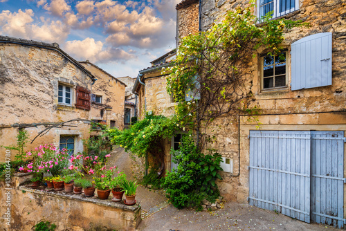 Fototapeta Naklejka Na Ścianę i Meble -  Charming street in quaint Menerbes village with colorful buildings and vibrant flowers. Village of Menerbes (Most Beautiful Village in France) in the Luberon mountains, France, Luberon, Vaucluse.