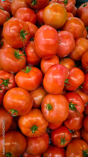 colorful arrangement of fresh, ripe red tomatoes stacked together, showcasing their natural texture and vibrancy, perfect for culinary, market, or agricultural themes.
