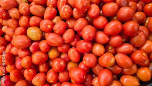 colorful arrangement of fresh, ripe red tomatoes stacked together, showcasing their natural texture and vibrancy, perfect for culinary, market, or agricultural themes.