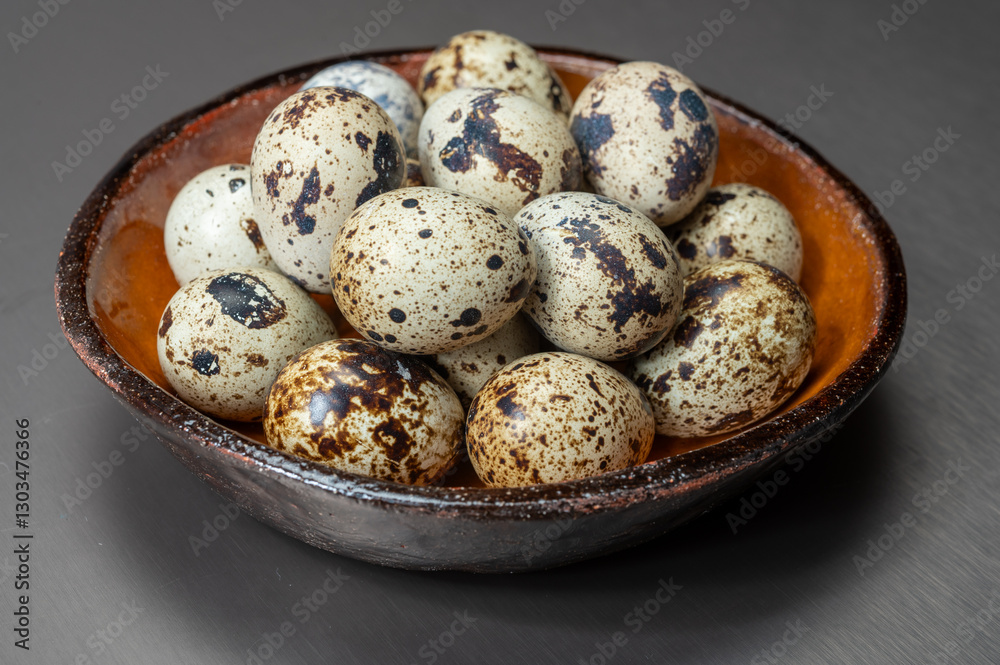 Fresh small spotted partridge or quail bird eggs uncooked