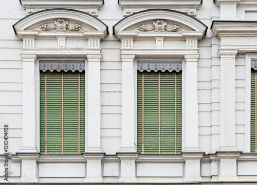 Beautiful old windows with closed shutters