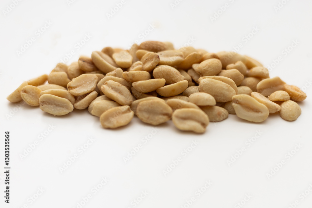 a handful of peanuts on a white table a handful of peanuts on a white table
