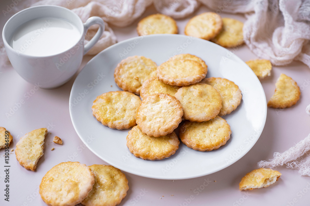 Sweet biscuits for dessert on a white plate. Delicious cookies for breakfast on a plate on a light background. Close-up. Sweet biscuits for dessert on a white plate. Delicious cookies for breakfast on a plate on a light background. Close-up.
