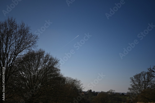 beautiful blue sky with contrail heading to the heavens