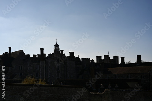 old estate building silhouette against a clear blue sky 