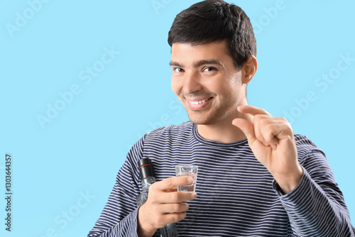 Young man with glass and bo...