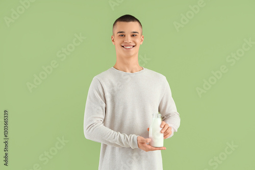 Teenage boy with bottle of ...