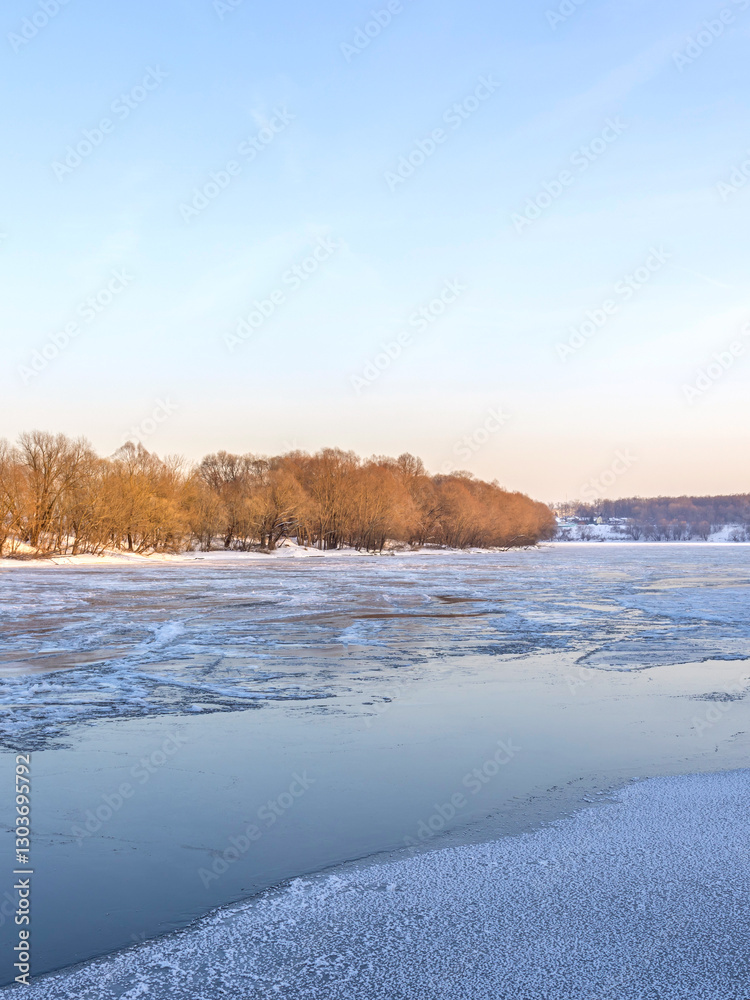 Frozen lake with trees in the background Frozen lake with trees in the background