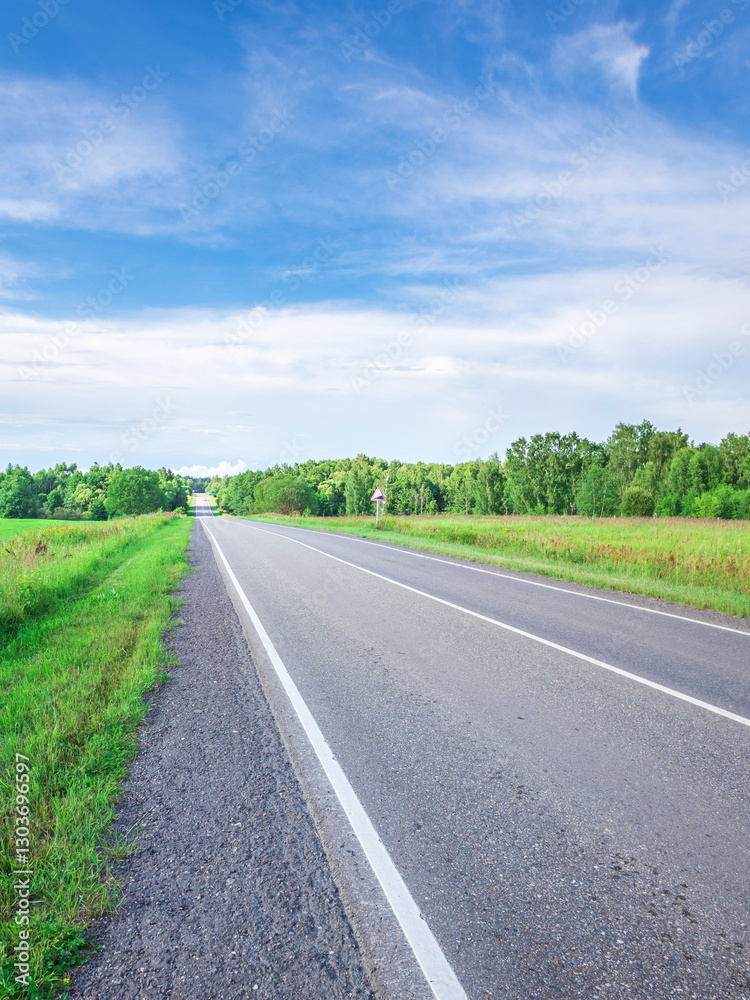 Fototapeta premium Long road with a clear blue sky above it