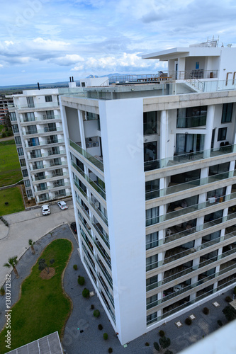 Modern architecture showcases luxury living in an expansive coastal city under a cloudy sky