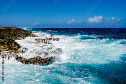 waves crashing on the rocks of the shoreline on island of Curacao in Caribbean 