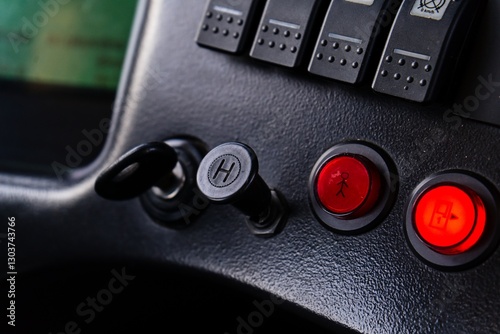 Close-Up of Bus Dashboard Controls with Key and Buttons
