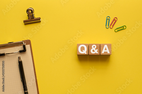 There is wood cube with the word Q&A. It is an abbreviation for question and answer as eye-catching image.