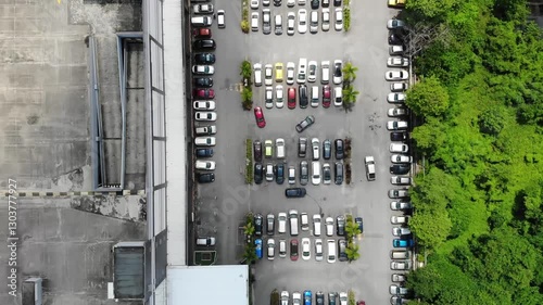 Aerial top down view of many cars in a large carpark.