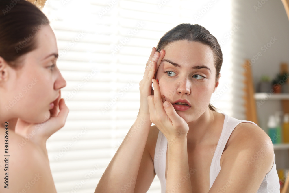 Young woman putting in red color contact lens near mirror indoors Young woman putting in red color contact lens near mirror indoors