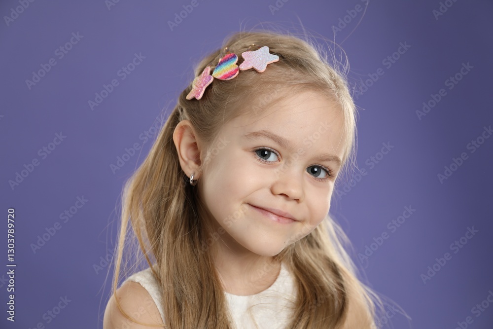 Cute little girl with beautiful hair clips on violet background Cute little girl with beautiful hair clips on violet background