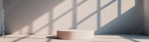 Minimalist marble podium casting shadows in bright room, showcasing modern design and simplicity. interplay of light and shadow creates serene atmosphere