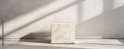 Minimalist marble podium with contrasting light and shadows, creating serene atmosphere. Ideal for showcasing products or art in modern setting