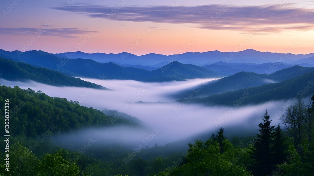 Fototapeta premium A sweeping valley with layered mountains emerging through soft morning fog