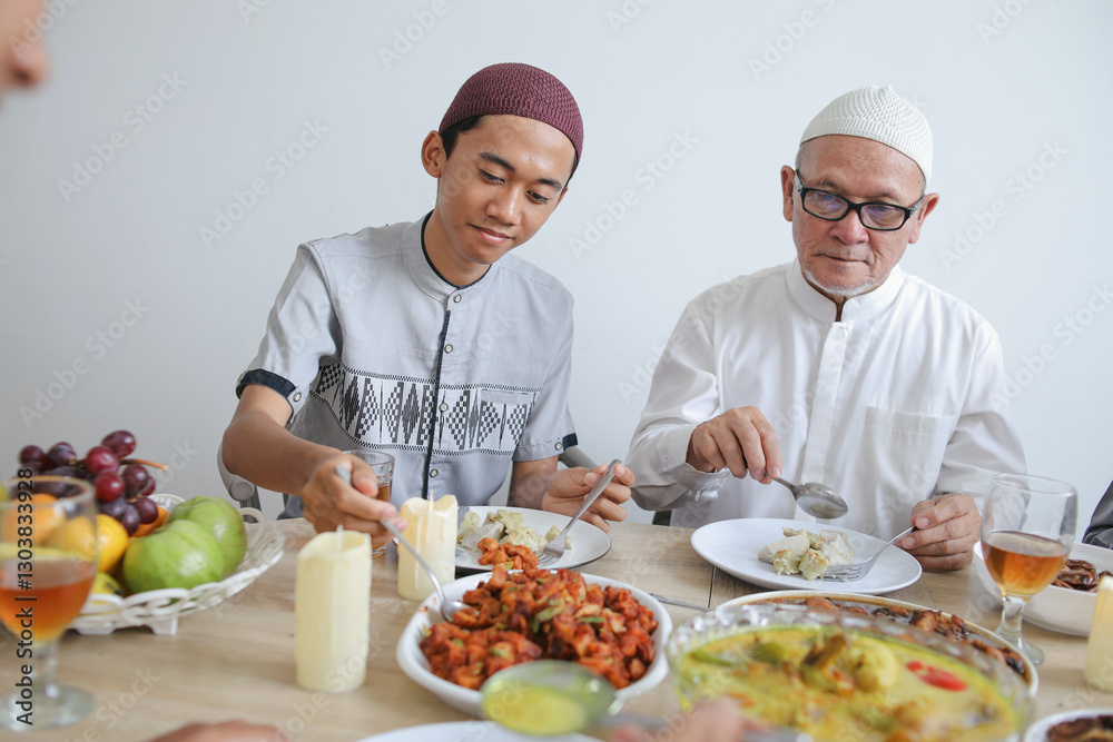 Portrait Of Young Asian Muslim Man Taking Food Together With His Grandfather on Celebrating Eid Al Fitr Portrait Of Young Asian Muslim Man Taking Food Together With His Grandfather on Celebrating Eid Al Fitr