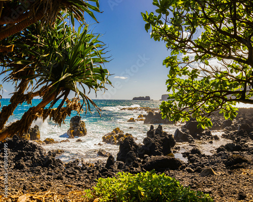 The Volcanic Shoreline of Keanae Point With Moku Manu Islet Across Hahana Bay, Keanae, Maui, Hawaii, USA photo