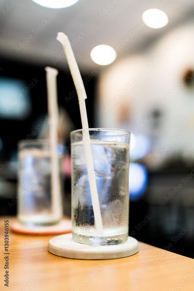 Refreshing ice with water served in clear glass cups on a dinner table, drinking water at dinner meal time at the restaurant Refreshing ice with water served in clear glass cups on a dinner table, drinking water at dinner meal time at the restaurant