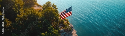 An American flag is flying on the cliff overlooking Lake Michigan, an aerial view captured by a drone.