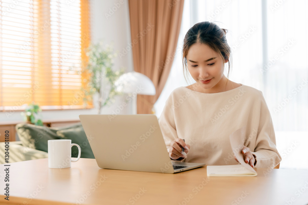 Young Asian woman happy positive cute beautiful business woman sit indoors in living room using laptop computer Young Asian woman happy positive cute beautiful business woman sit indoors in living room using laptop computer