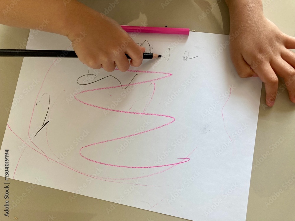 Little Hands Toddler Doodling Creating Art. Drawing on Paper. with Colored Pencils.
