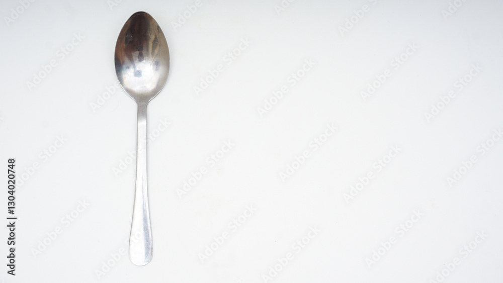 Top view of stainless steel spoon with copy space isolated on white background Top view of stainless steel spoon with copy space isolated on white background