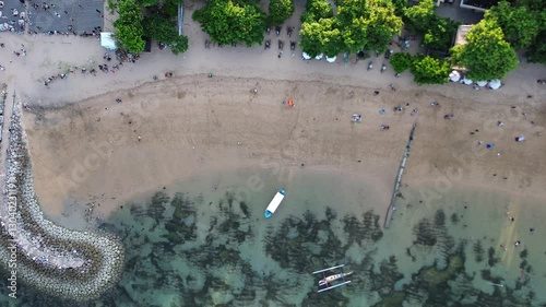Sanur beach Bali beautiful sand beach with scenery fishing boat in ocean and restaurants along the coast island Bali