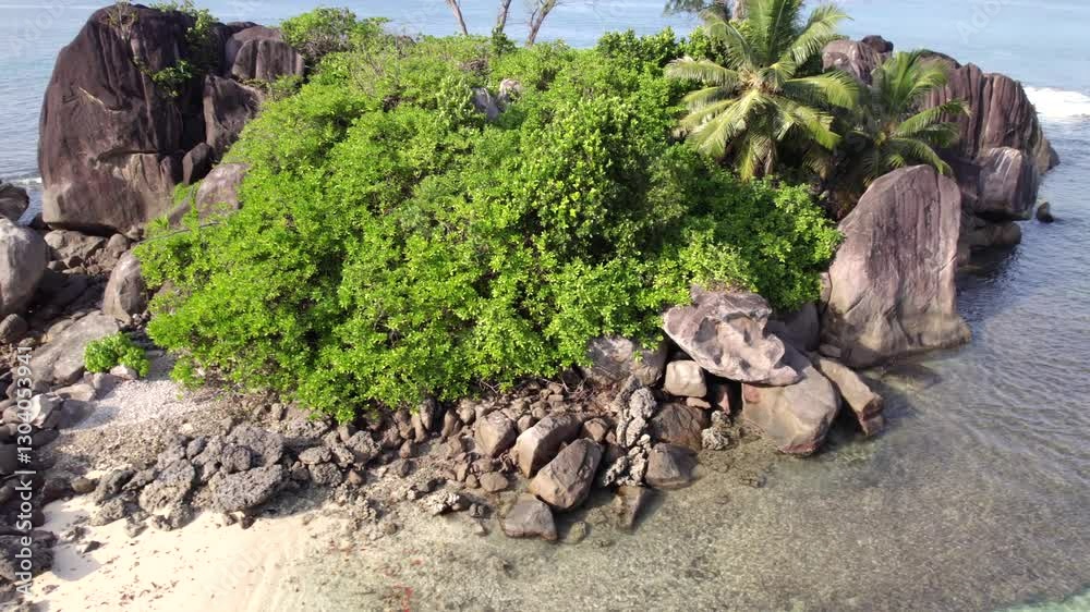 Drone shot of port glaud white sandy beach near granite rocks and palm trees Mahe Seychelles 30fps 1. Drone shot of port glaud white sandy beach near granite rocks and palm trees Mahe Seychelles 30fps 1.