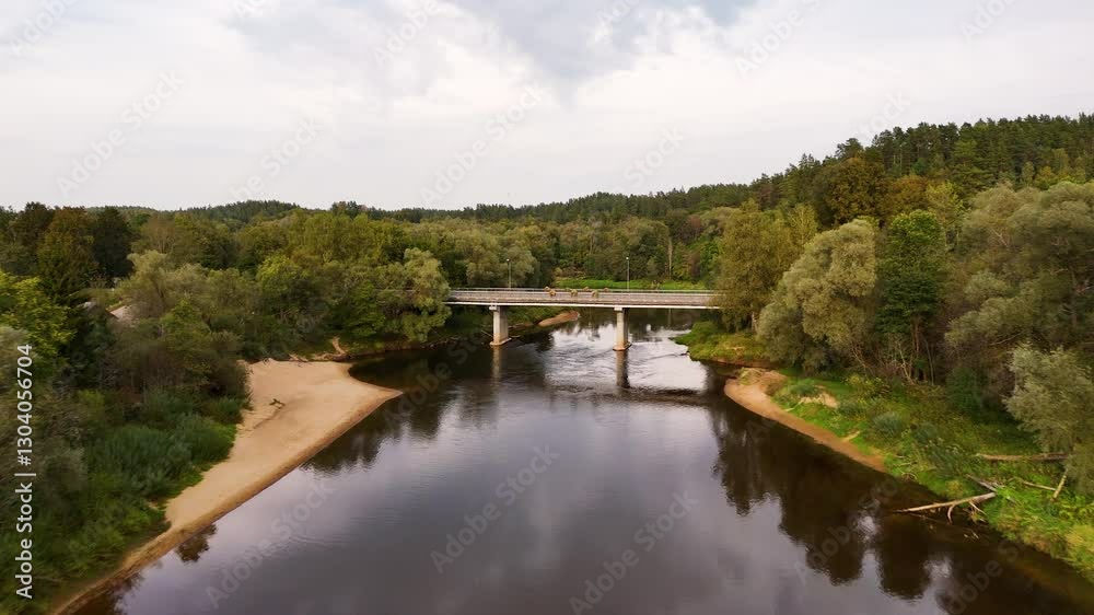 Aerial Drone Flying Over The Gauja River Approaching A Concrete Bridge In The Historic Town Of Cesis, Latvia. Aerial Drone Flying Over The Gauja River Approaching A Concrete Bridge In The Historic Town Of Cesis, Latvia.