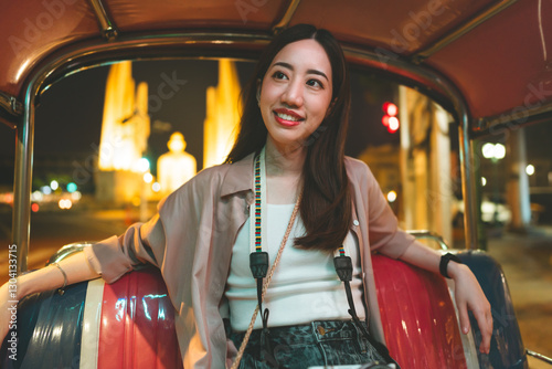 Photography Asian woman solo travel enjoy life moment night trip at Bangkok city sitting in